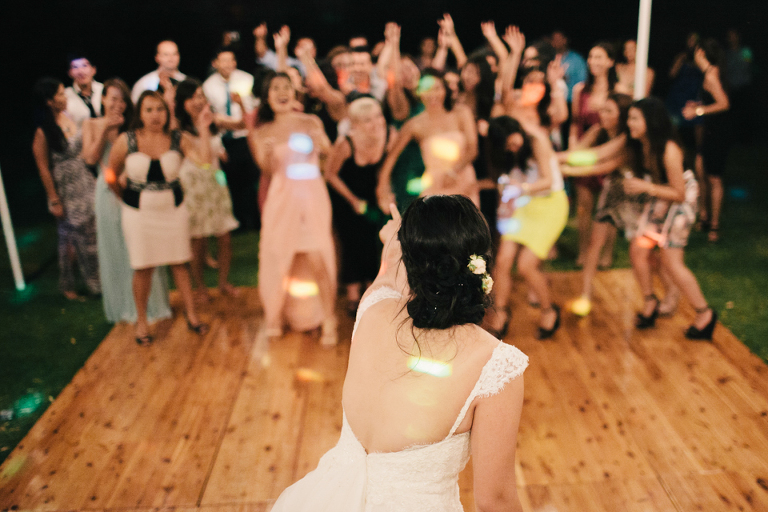 Bouquet toss outside under the stars