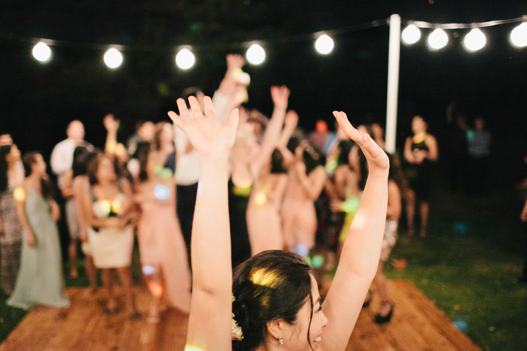 Bouquet toss outside under the stars