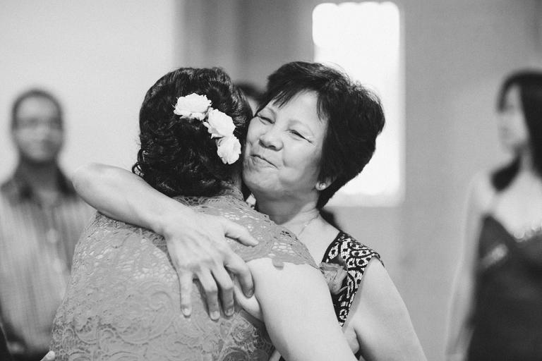 Mother of the groom hugs the bride