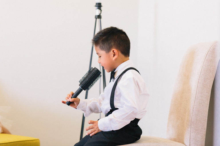 Page boy having fun at a wedding singing