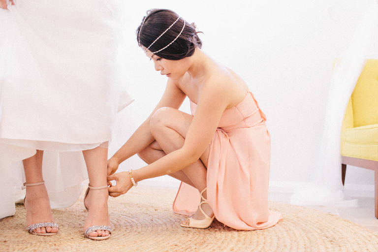 Putting shoes on wedding getting ready
