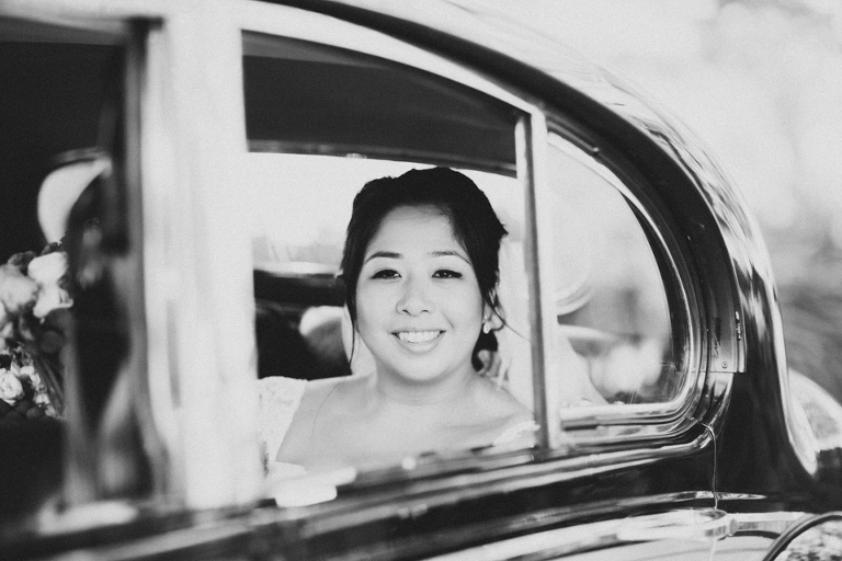 Bride arriving in car black and white photography