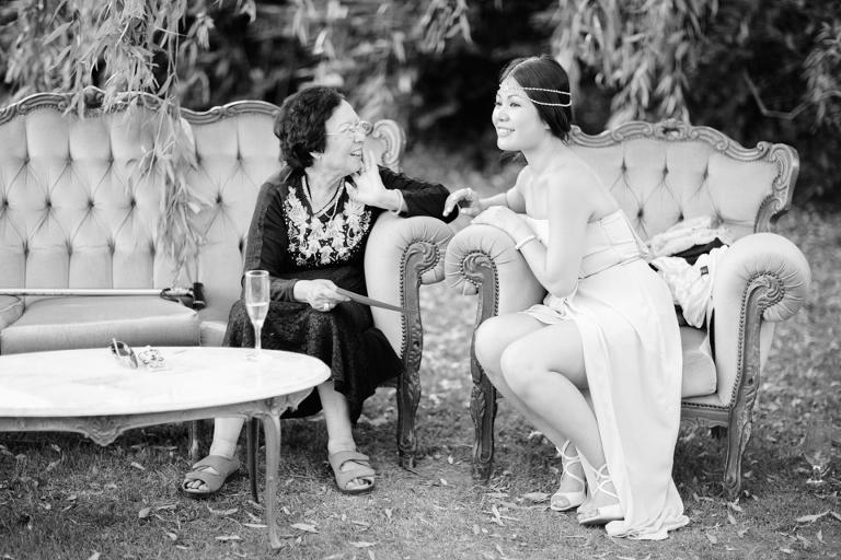 Bridesmaid laughing with grandma at wedding reception