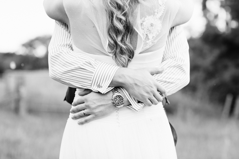 Bride and groom with wrist watch in black and white