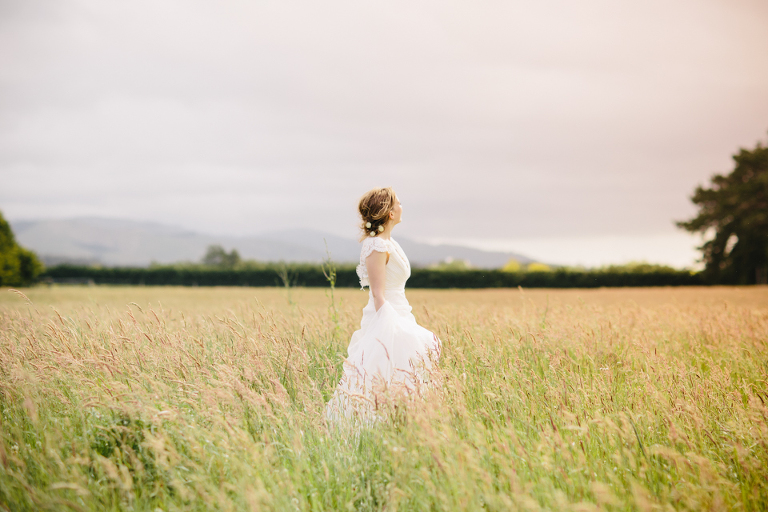 Ethereal bride in field of long grass