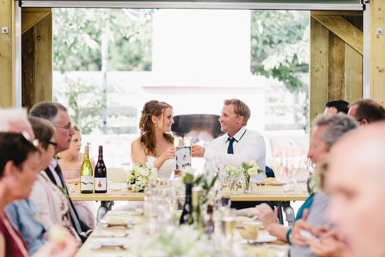 Bride and groom toast outdoor wedding reception Te Horo Beach wedding natural light