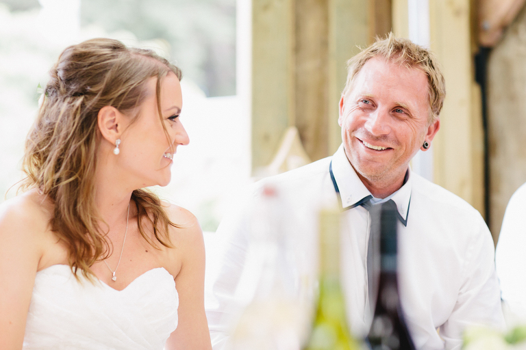 bride and groom smiling outdoor wedding reception Te Horo Beach wedding black and white