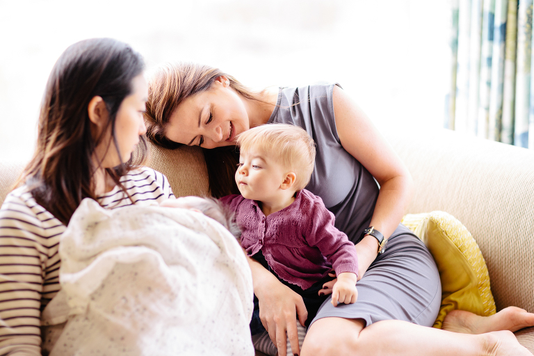 mom and aunt with newborn and older baby on couch Wellington in home, family photography, natural light 