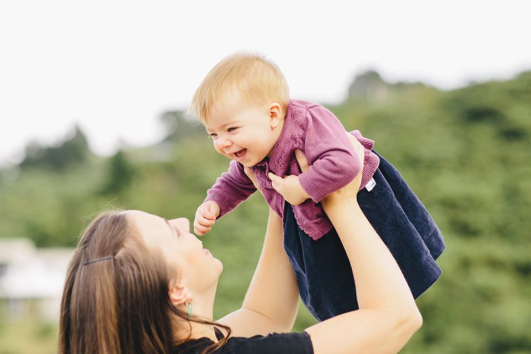 moml lifying baby girl in the air Wellington in home, family photography, natural light 