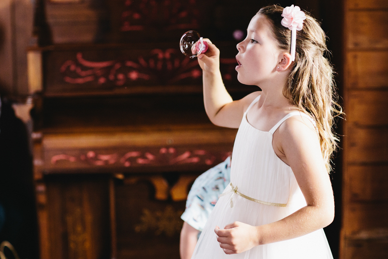 flower girl blowing bubbles at ceremony Burnside Church Martinborough Wedding natural light 