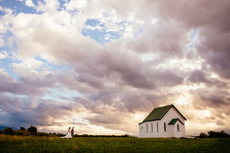 bride and groom walking towards chapel Burnside Church Martinborough Wedding natural light 