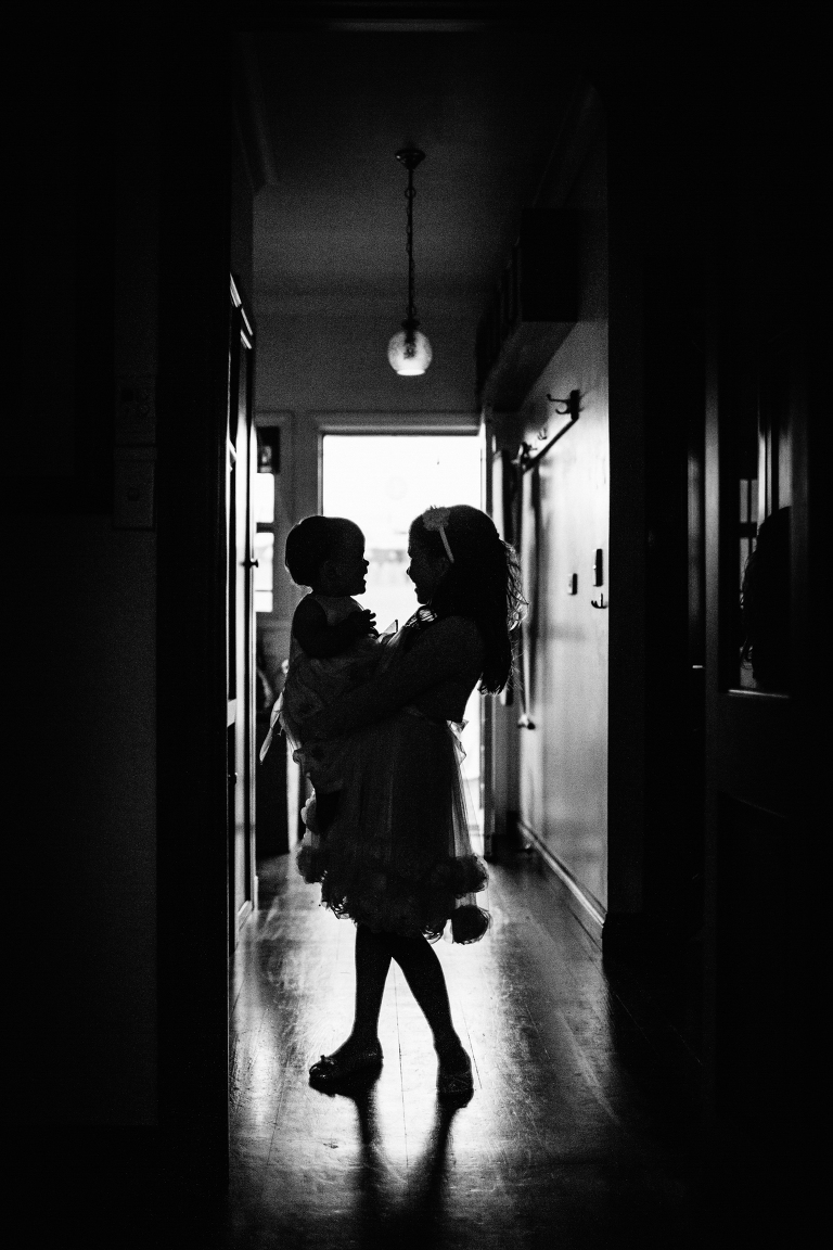 flower girl holding baby silhouette Burnside Church Martinborough Wedding black and white