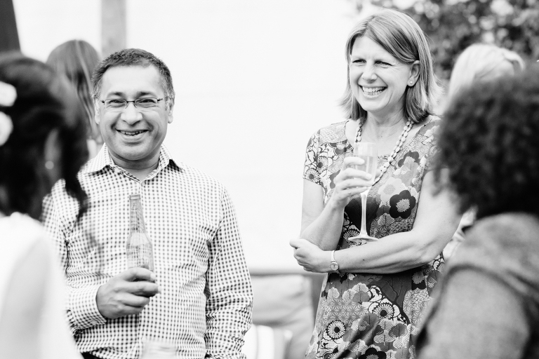 guests smiling at reception with champagne Burnside Church Martinborough Wedding natural light black and white