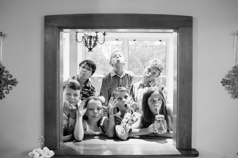 children making silly faces during reception at Burnside Church Martinborough Wedding natural light black and white