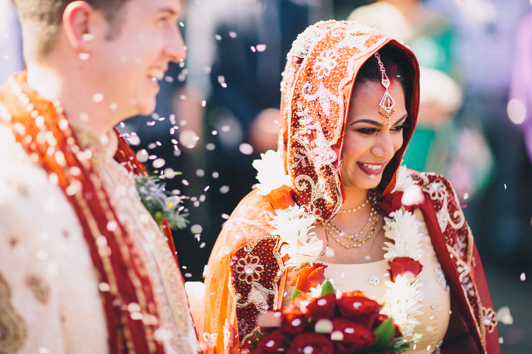  bride and groom with flowers in the air leaving ceremony Pauatahanui Inlet Wellington wedding natural light