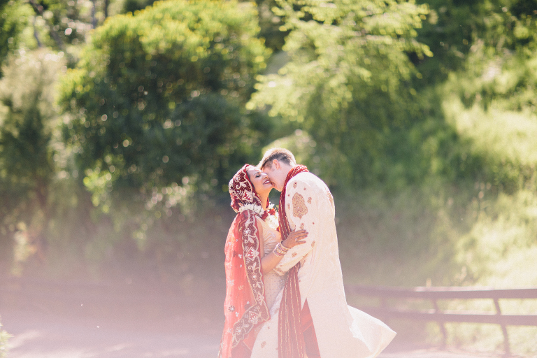 bride and groom kissing surrounded by trees Pauatahanui Inlet Wellington wedding natural light