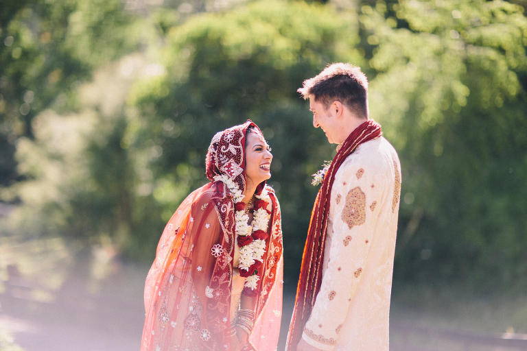 Bride and groom laughing, surrounded by trees Pauatahanui Inlet Wellington wedding natural light