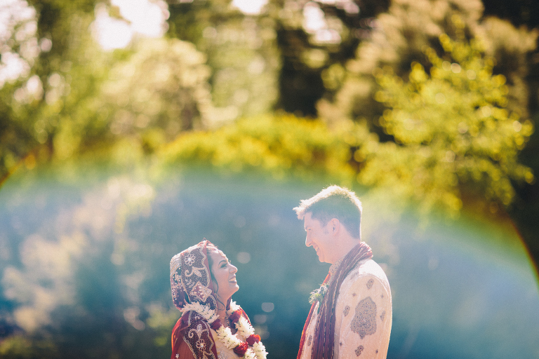 Bride and groom looking into each others eyes surrounded by trees Pauatahanui Inlet Wellington wedding natural light
