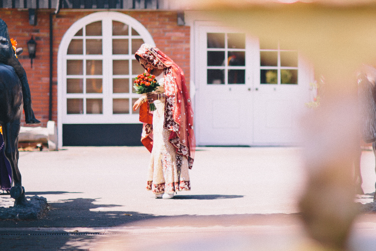 Bride with flowers in colorful sari with decorative head covering Pauatahanui Inlet Wellington wedding
