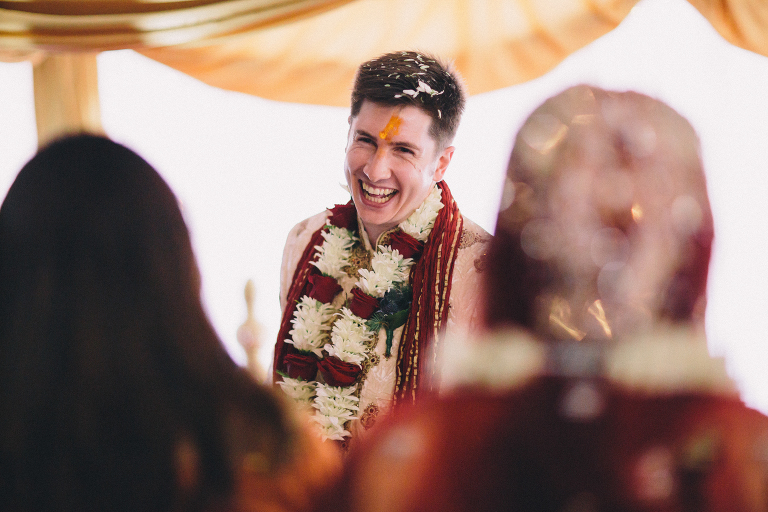  groom laughing and smiling at bride during ceremony Pauatahanui Inlet Wellington wedding natural light