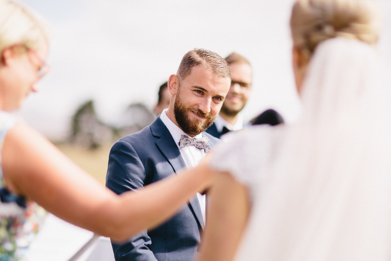 groom smiling at bride during ceremony Martinborough Brackenridge Estate wedding natural light 