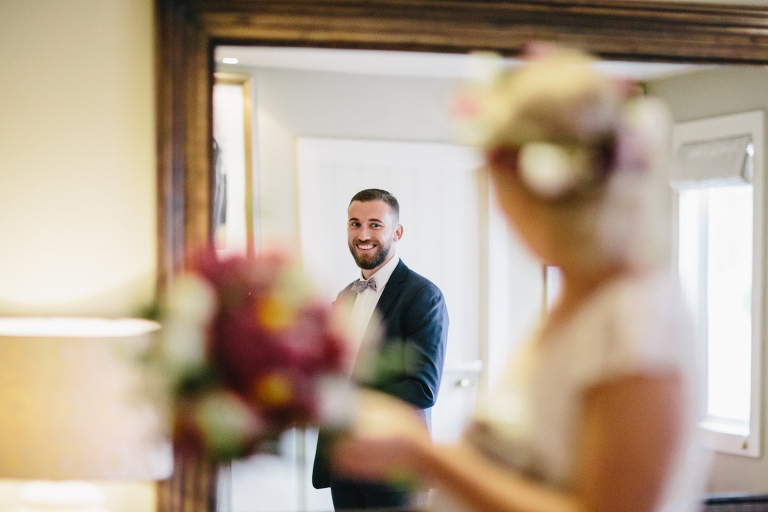 groom smiling at bride across the room at reception Martinborough Brackenridge Estate wedding natural light 