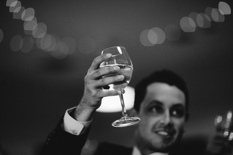 Guest toasting during reception Martinborough Brackenridge Estate wedding natural light black and white