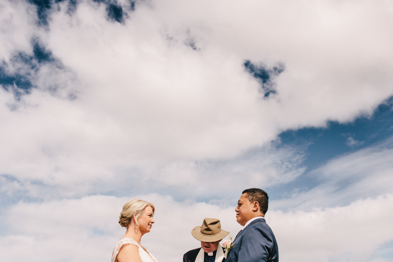 Bride and groom with minister during ceremony Riversdale Wedding natural light