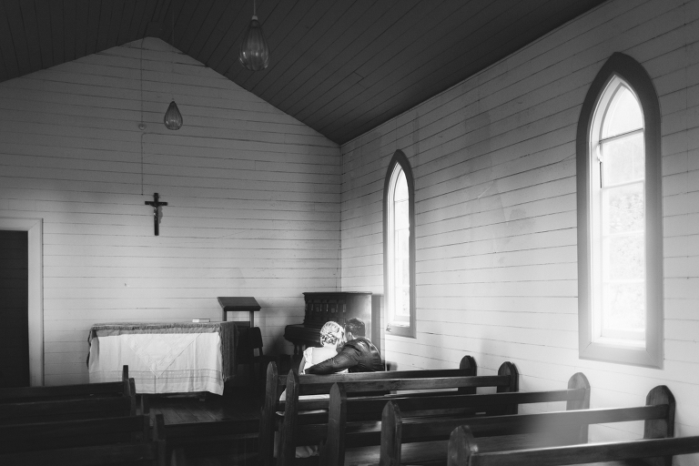 bride and groom sitting inside chapel Riversdale Wedding natural light black and white