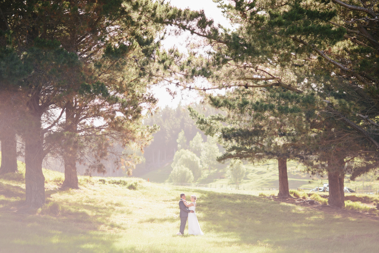 bride and groom holding each other in the woods on rustic road Riversdale Wedding natural light 