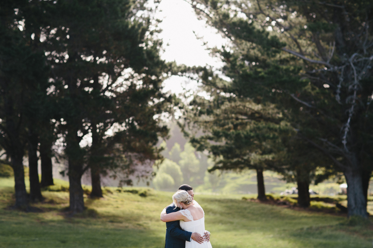 bride and groom hugging surrounded by trees Riversdale Wedding natural light 