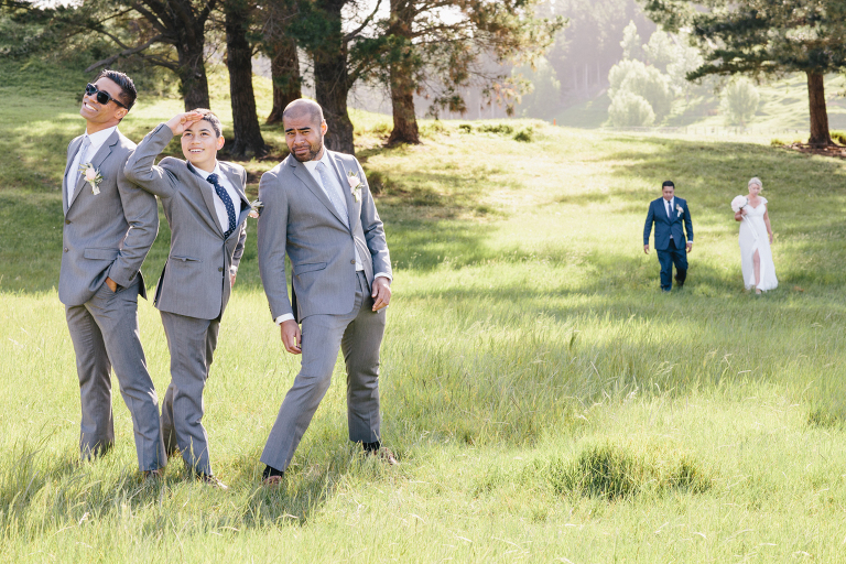 Bride and groom walking up the rustic road with the groomsmen in foreground Riversdale Wedding natural light 