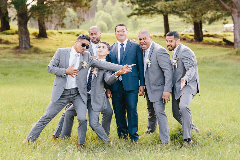 Groom and groomsmen laughing and being silly outside Riversdale Wedding natural light 