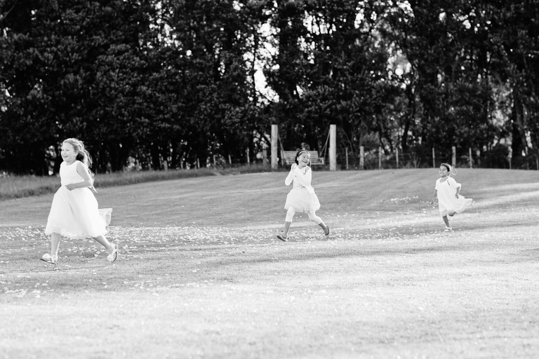 three young girls running outside at Riversdale Wedding natural light black and white