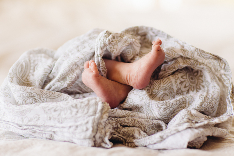 baby girl feet wrapped in blanket on bed Newborn Photography Wellington