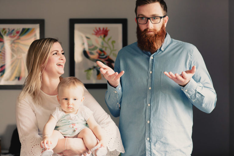 mum and dad with baby girl natural light In-Home Photography First Birthday Party