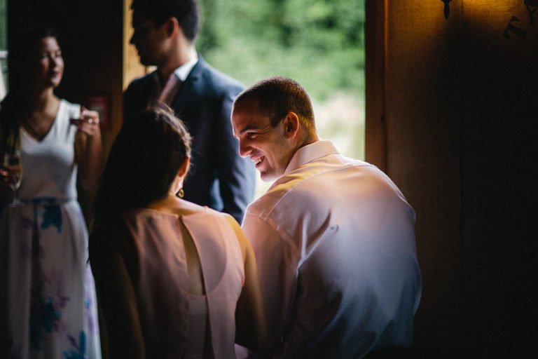 bride and groom smiling at reception view from back natural light Wellington rainy day wedding