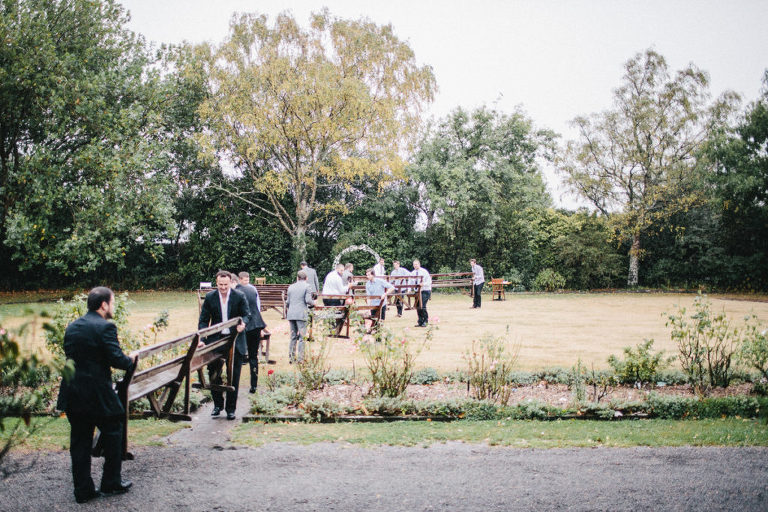 wedding party walking through field natural light Wellington rainy day wedding