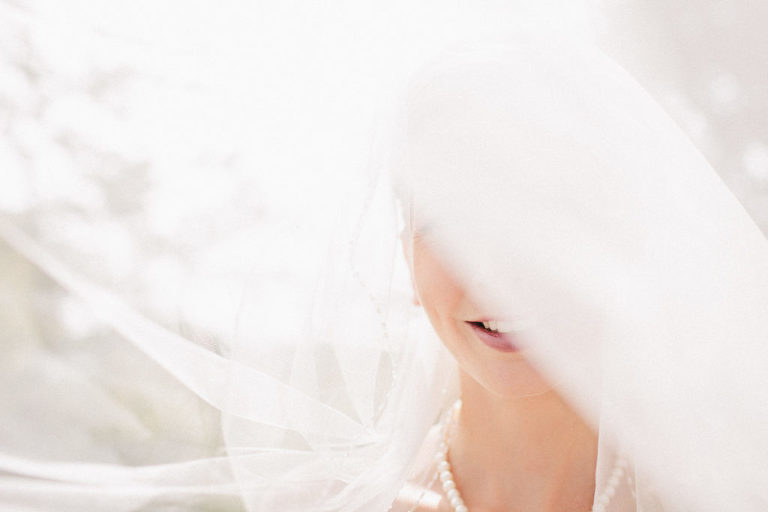 bride with veil in sunlight natural light Wellington rainy day wedding