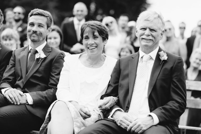 family watching ceremony smiling black and white natural light Wellington wedding