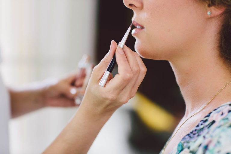 bride putting makeup on before ceremony natural light Wellington wedding