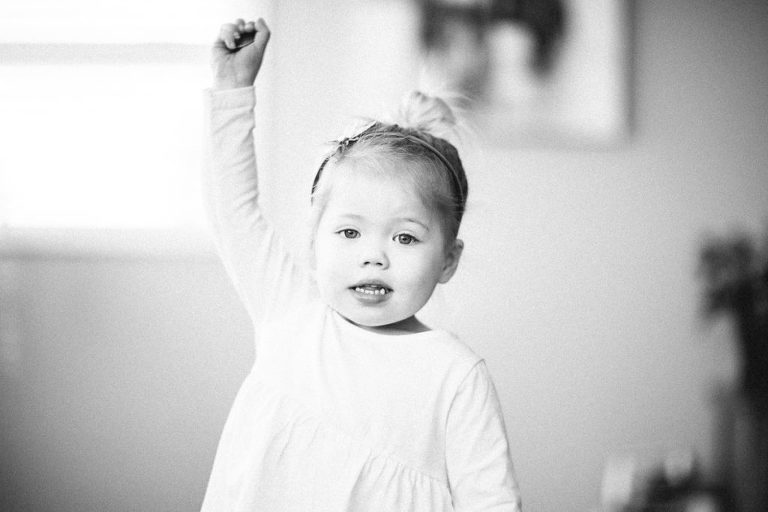 close up little girl with arm raised natural light black and white family photography Wellington